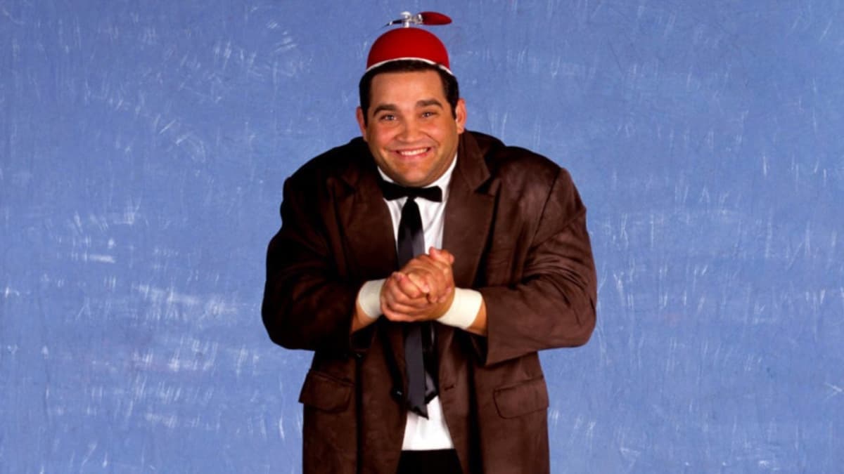 Beaver Cleavage wearing a brown suit and red propeller hat