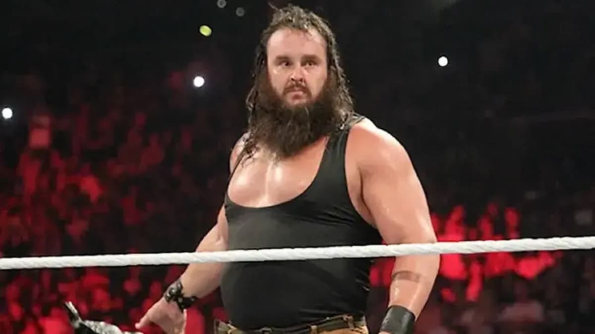 Braun Strowman with a beard and black vest standing on the ring apron for his WWE debut