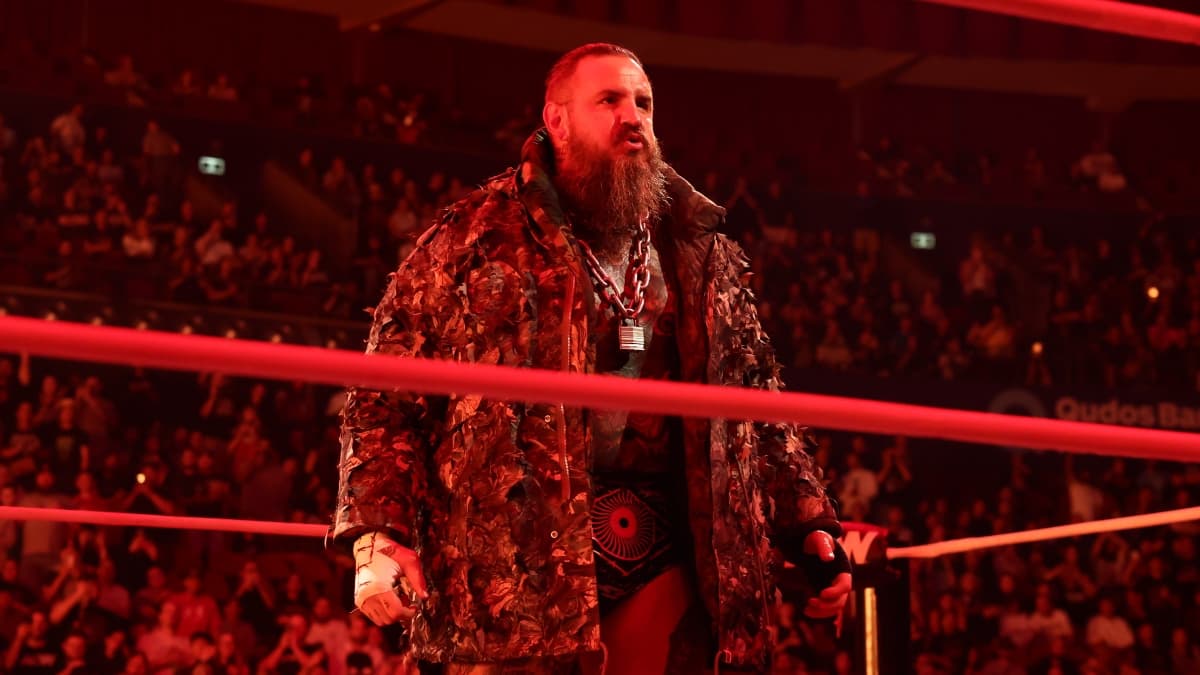 Brody King bathed in red light while wearing a lovely fur coat