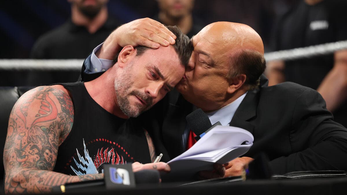 An emotional CM Punk being kissed on the head by Paul Heyman