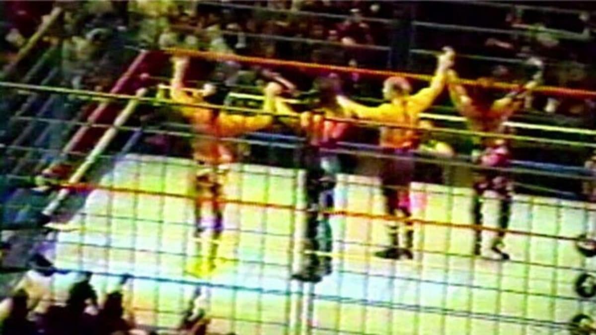 Razor Ramon, Diesel, Triple H, and Shawn Michaels raising their arms together in the WWF Curtain Call