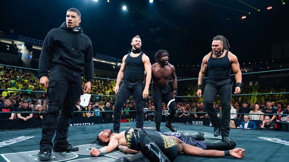 DarkState standingover Leon Slater and Je'Von Evans in the ring at TNA Bound For Glory