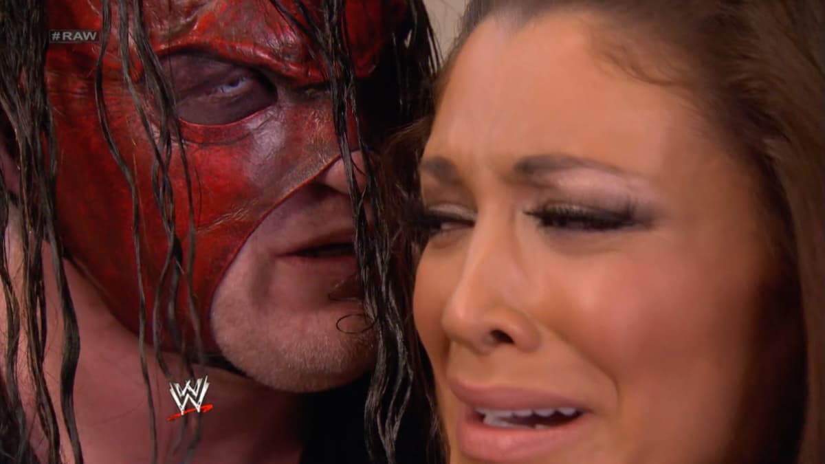 Kane staring at Eve Torres as she tries look away, terrified. 