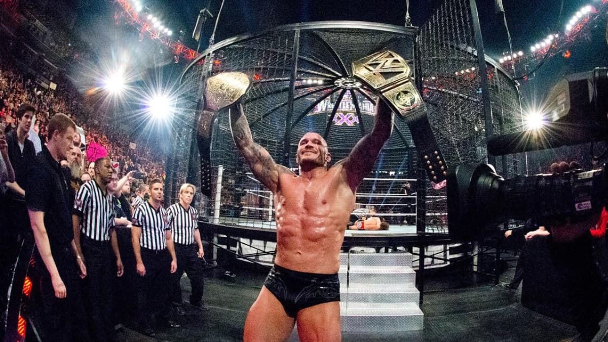 Randy Orton raisin the WWE and World Heavyweight Titles at Elimination Chamber 2014