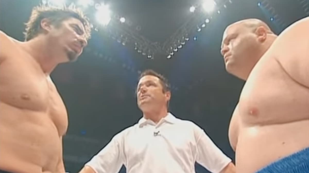 Sean O'Haire and Butterbean facing off as a referee in a white t-shirt stands between them