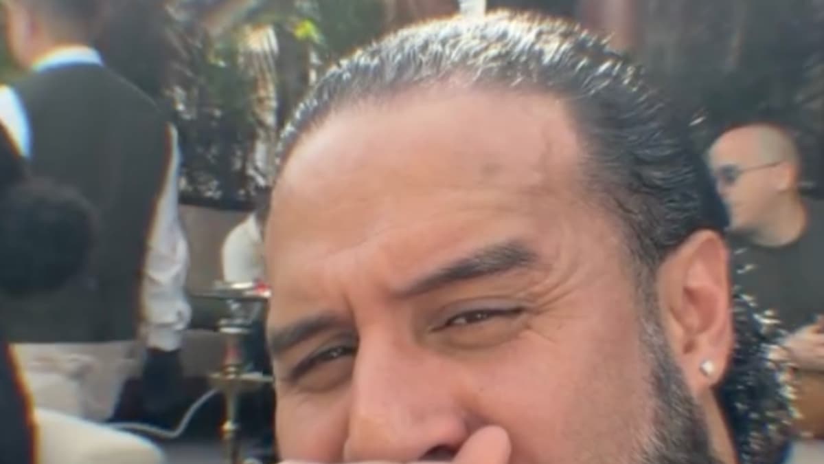 Tama Tonga with an unmasked Mr. Iguana sitting behind him in Saudi Arabia