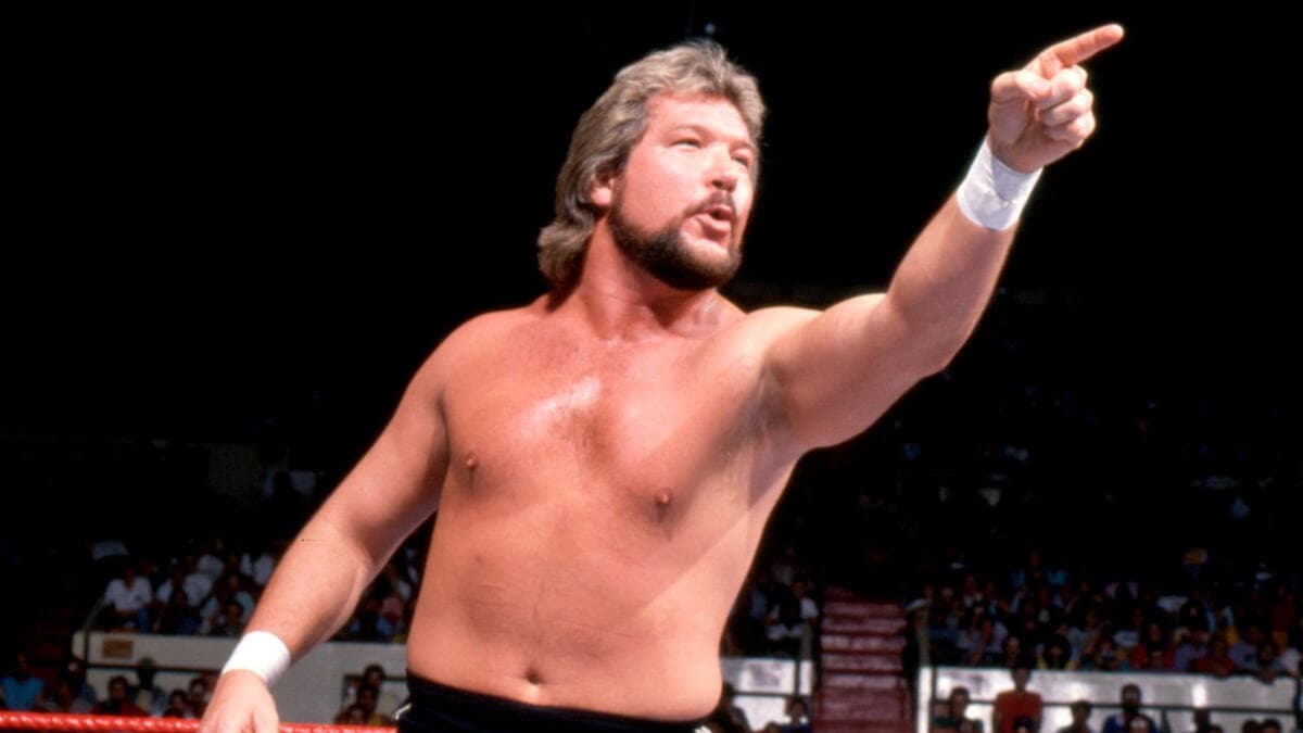 Ted DiBiase in black trunks pointing at some point in the 1980s