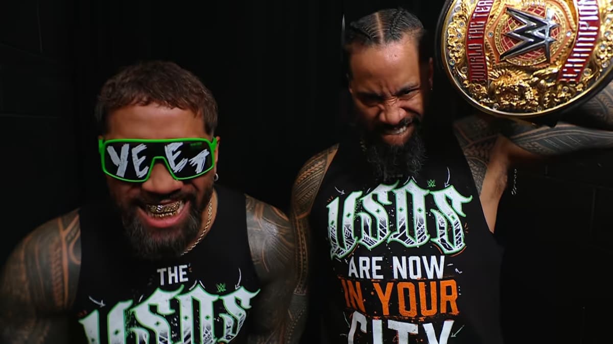 The Usos, with Jey wearing 'YEET' sunglasses and Jimmy holding up the World Tag Team Title