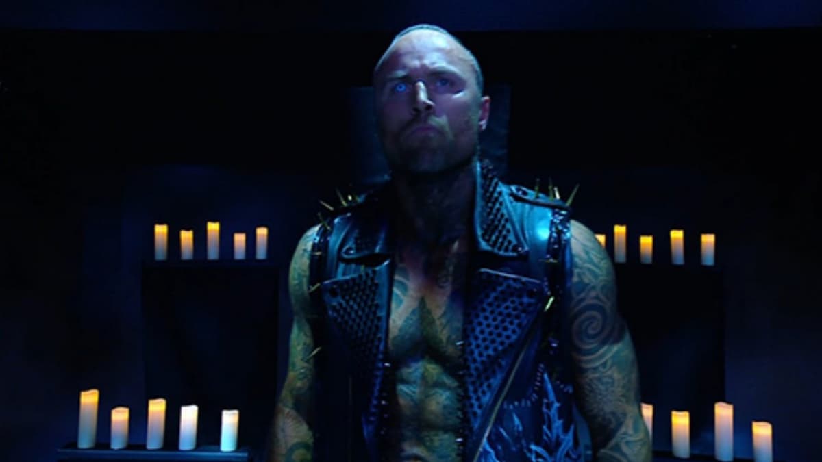 Aleister Black in front of candles
