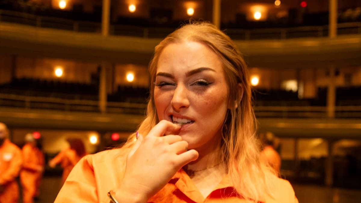Allie Katch in orange jumpsuit