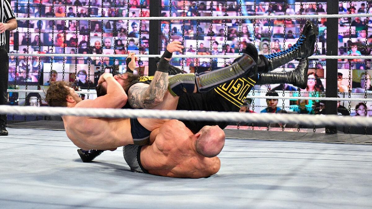 Daniel Bryan pulling at Kevin Owens' head as he hits a Senton to Cesaro