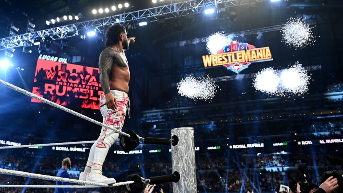 Jey Uso pointing to the WWE WrestleMania sign