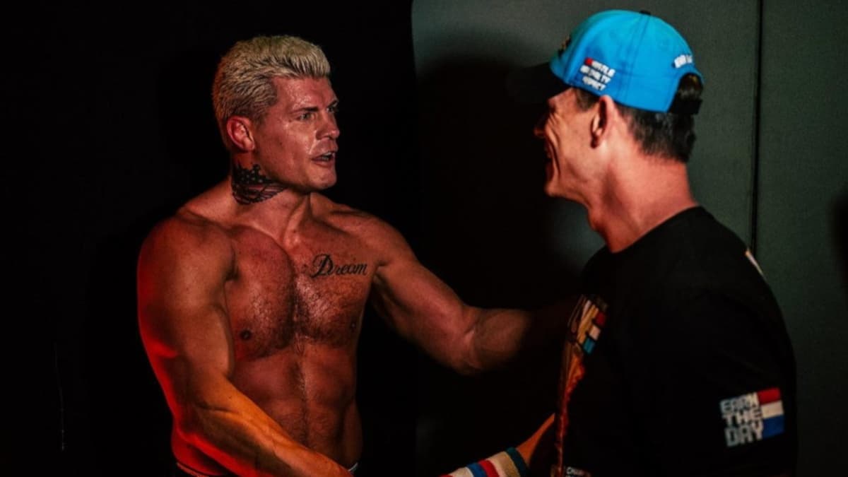 John Cena and Cody Rhodes shaking hands in a corridor