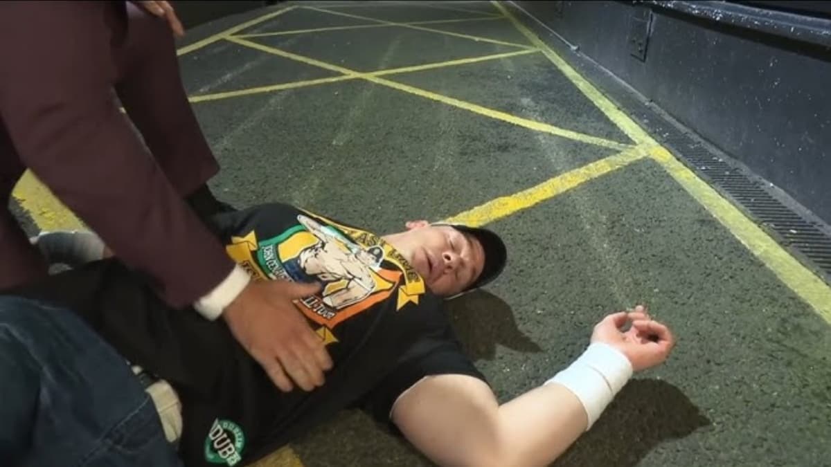 John Cena knocked out on the ground outside