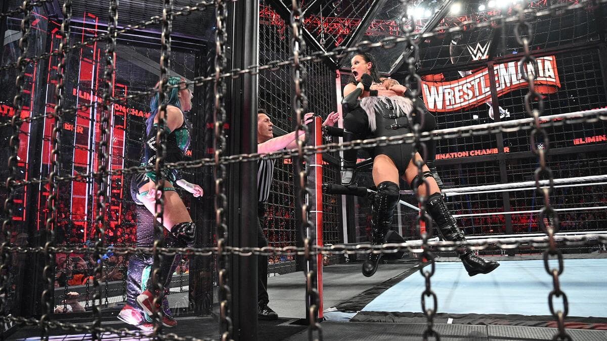 Shayna Baszler choking Liv Morgan while staring at Asuka